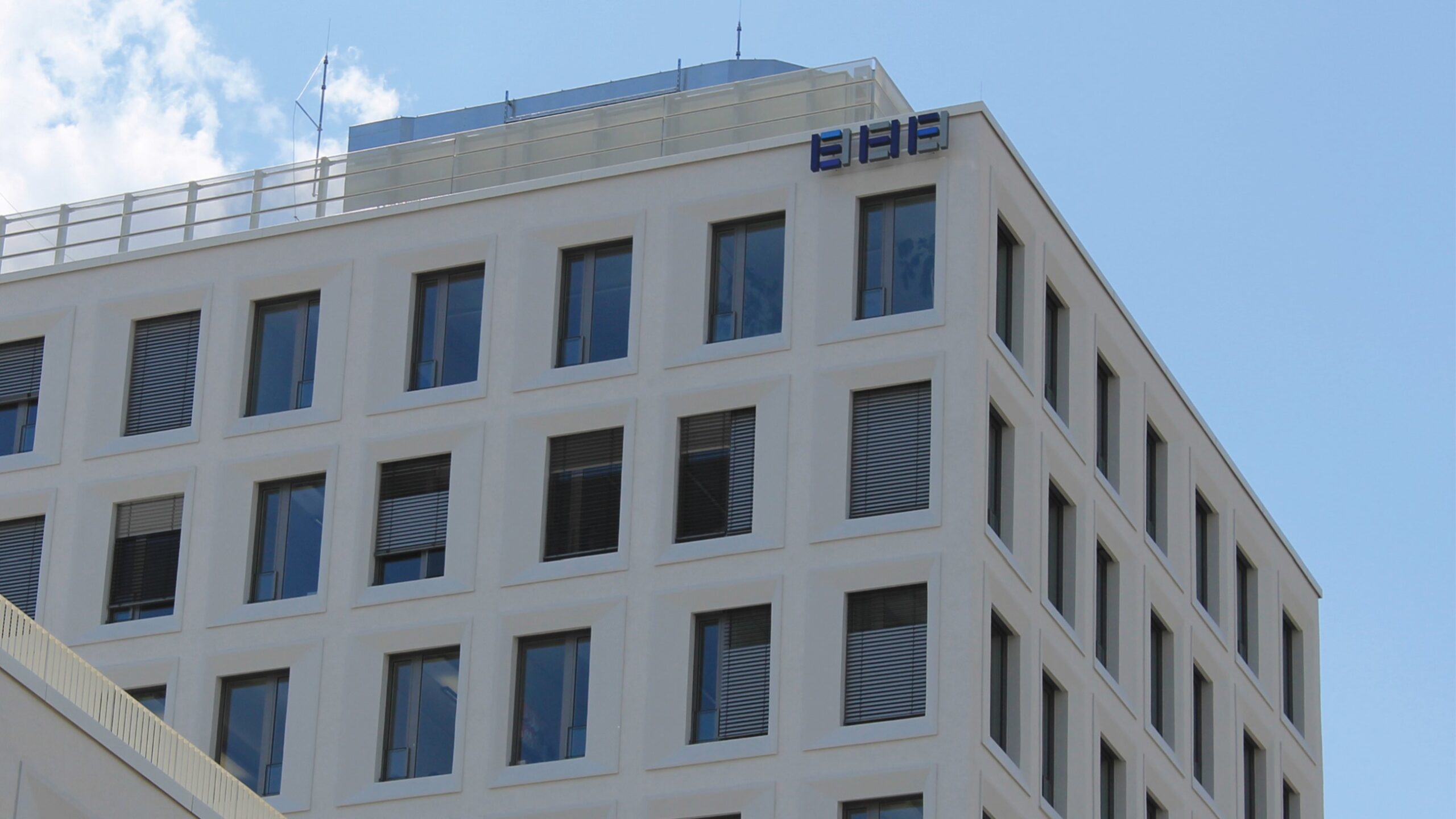 EHF building at Hirschgarten in Munich, bright facade of a high-rise building with many windows