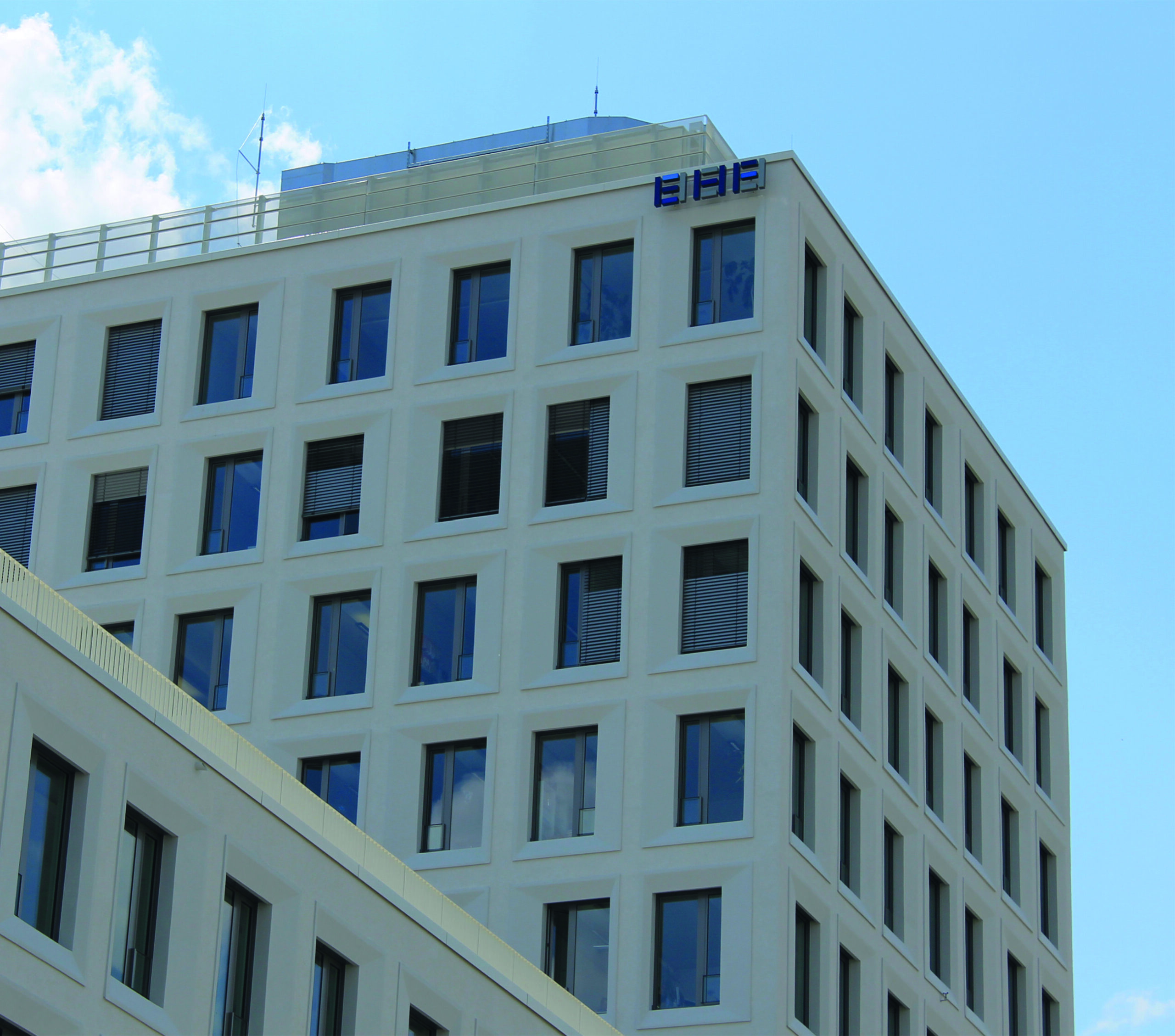 EHF building at Hirschgarten in Munich, bright facade of a high-rise building with many windows